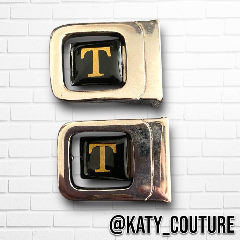 GOLD AND BLACK ‘T’ BELT BUCKLES.